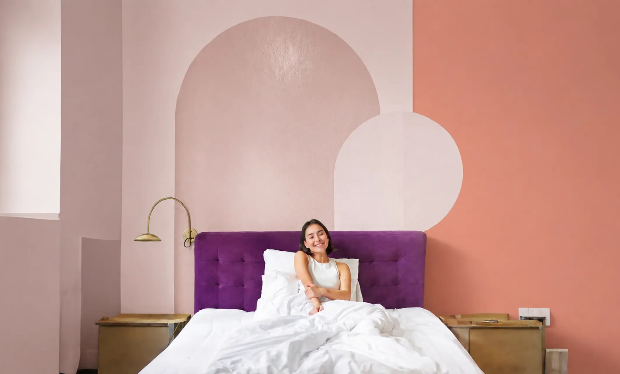 Qbode room styled with a purple velvet headboard