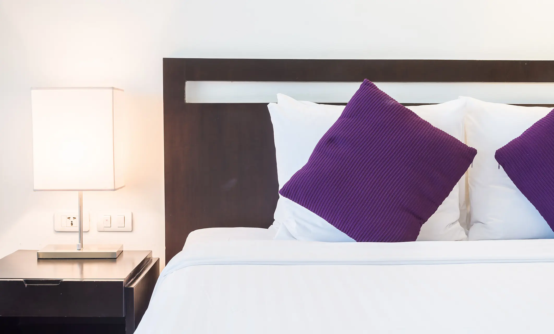 Qbode room with purple accent pillows